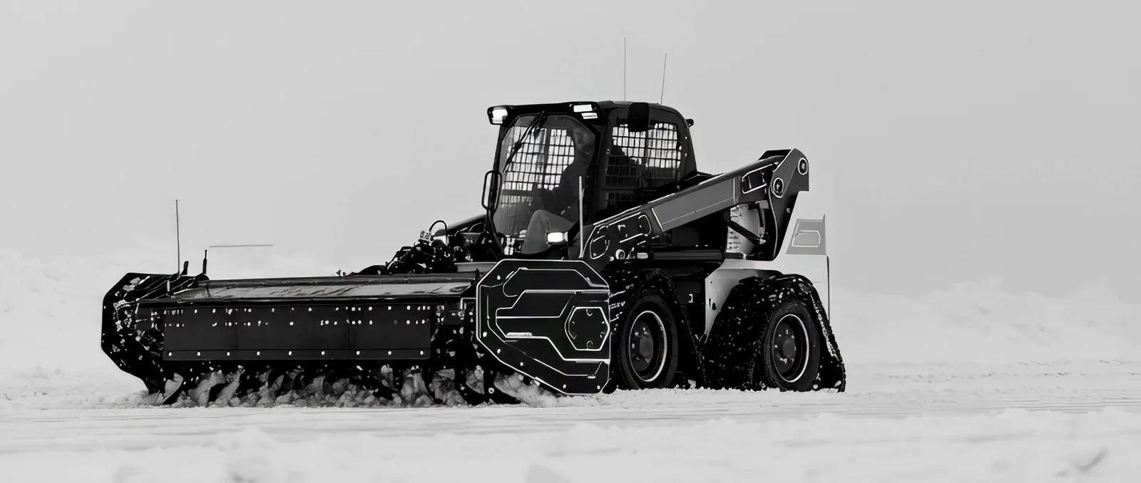 Tracked loader pushing snow with a full-width blade, flat overcast light.